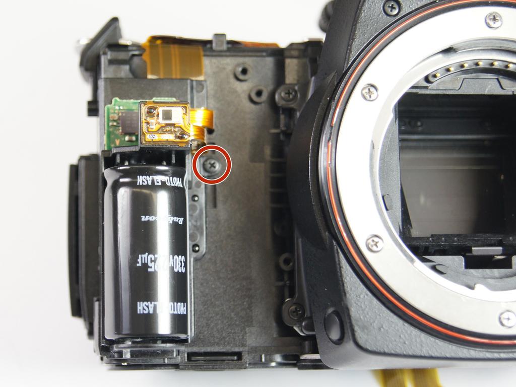 Use tweezers to disconnect the final two plugs and completely remove the circuit board from the camera.