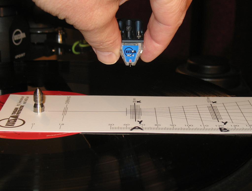 stylus is overhanging zero point B. If it is behind point B, push cartridge backwards towards the pivots of the tonearm for distance S (Fig.