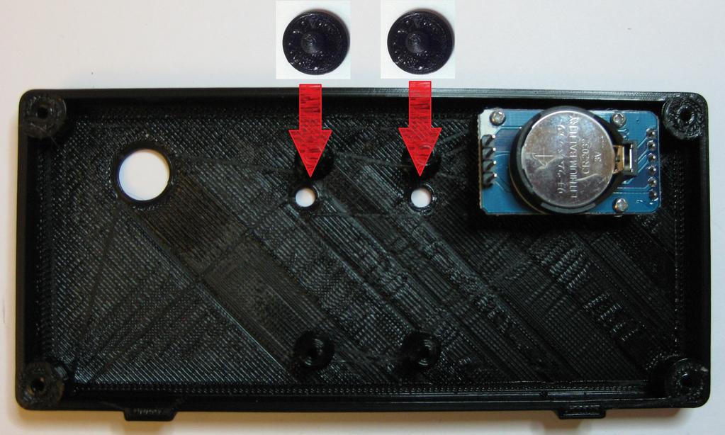 Place the two 3d printed buttons through the two holes (they have notches not shown in this picture to clear the