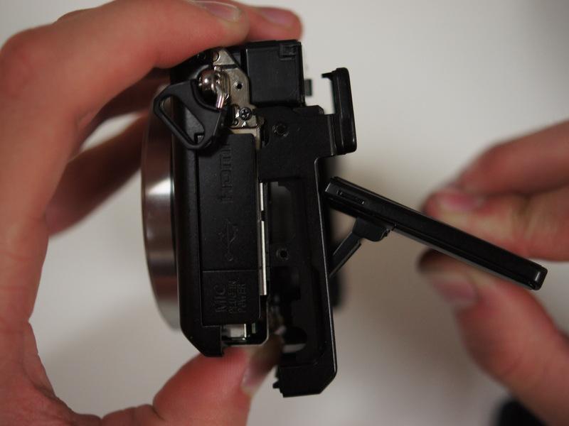 Once the back panel is free from the body, rotate the camera such that