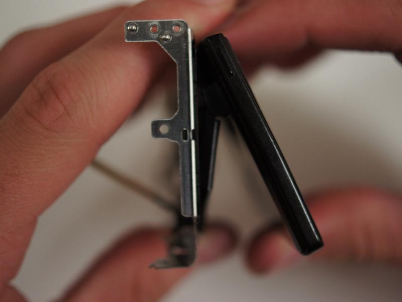 Unplug the cable by applying tweezers to the tabs on either side of