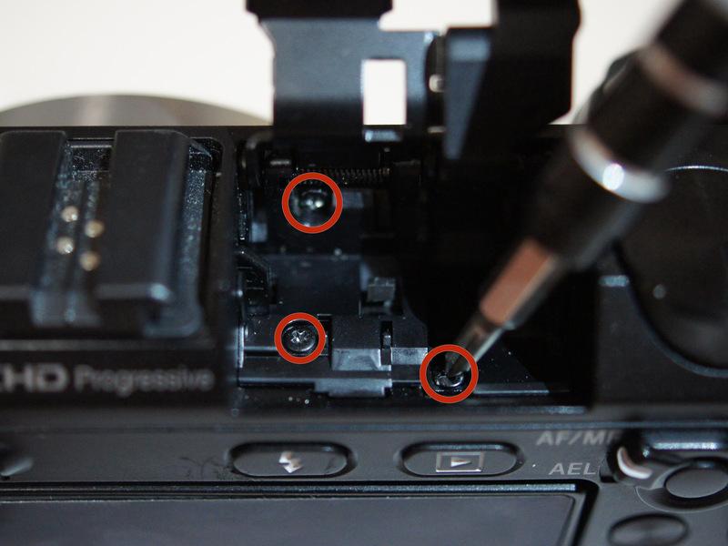 Remove the three 5/32" screws from within the flash compartment
