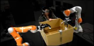 4. In this second scenario, a blindfolded operator holds the box while walking towards the robots.