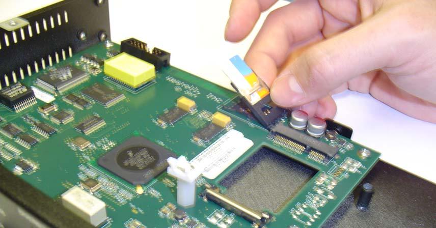 3. The SIM chip slides into a card holder on the back edge of the circuit board, shown in Figure 1-2. Follow the steps shown in Figure 1-3 to install the SIM.