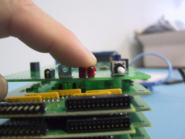 7 As shown in the following illustration, press firmly on the top of the LEDs to seat them on the surface of the main board.