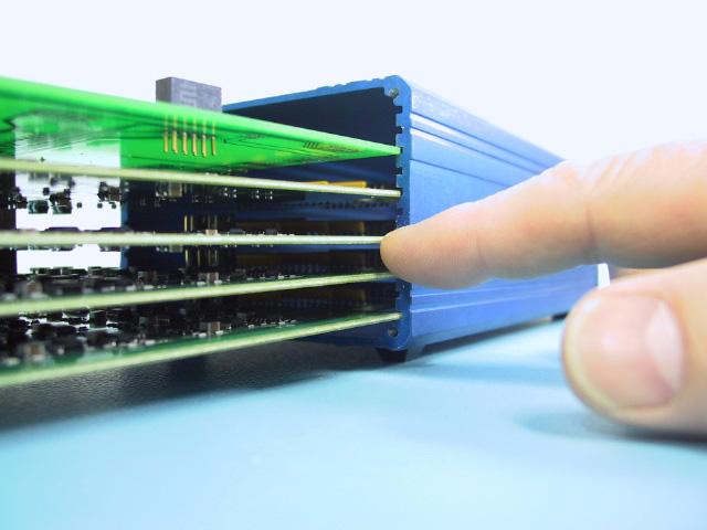 As shown in the following illustration, press gently on the rear panel and align the non-connector side of each board with the correct