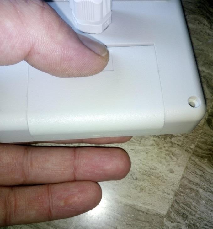 Figure 4. Instrument's protective cap removal After that, gently push the SD card with your finger.