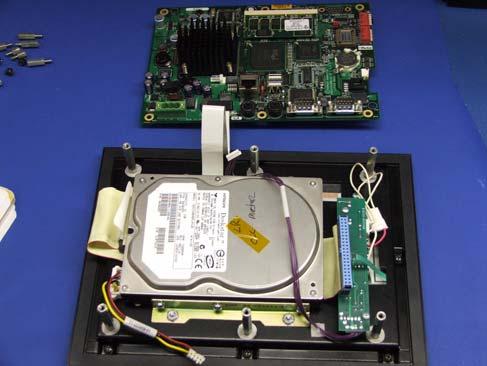 Working with Units Using a Hard Drive Figure 10: Accessing the Hard Drive 6 Remove the four nuts holding the
