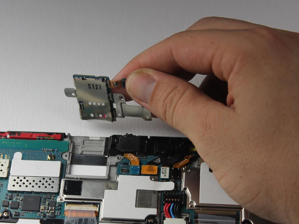 Step 10 Lift the SIM card reader off the motherboard, and replace it with a new SIM card reader.
