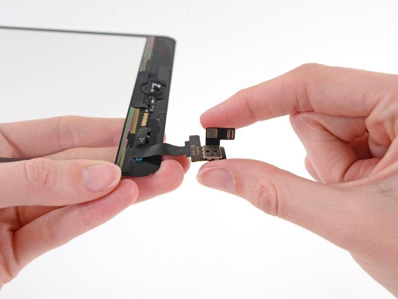 Remove the small piece of adhesive backing from the digitizer cable.