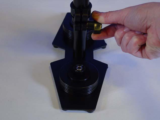Figure 24 Securely tighten the Adjustment Knob on the TELESCOPING CLAMP by rotating the Knob clockwise as shown