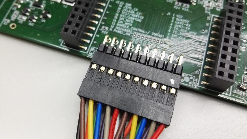 After soldering the header on the EXT2 board, you are able to connect the bridging cable with