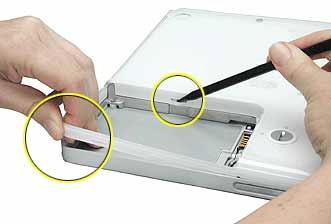 8. In the battery compartment, lift up the corner of the bottom case, and use a black