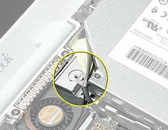 3. Lift up the ribbon cable, and remove the screw at the battery bay. 4. Warning: Handle the optical drive at the sides only. Do not touch or press anywhere else on the drive.