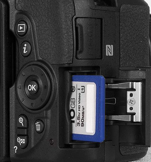 4. Insert a memory card. Open the card-slot cover on the right side of the camera and orient the card as shown in Figure 1-2 (the label faces the back of the camera).