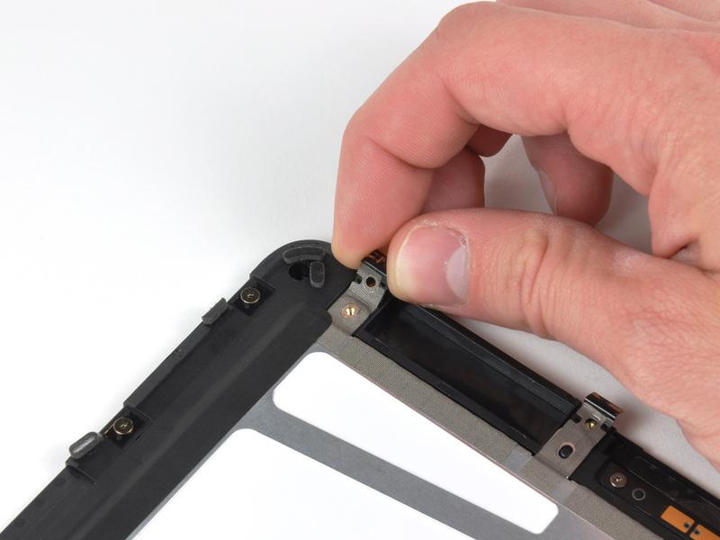 Carefully peel the display clip and its attached tape off the black plastic display frame.