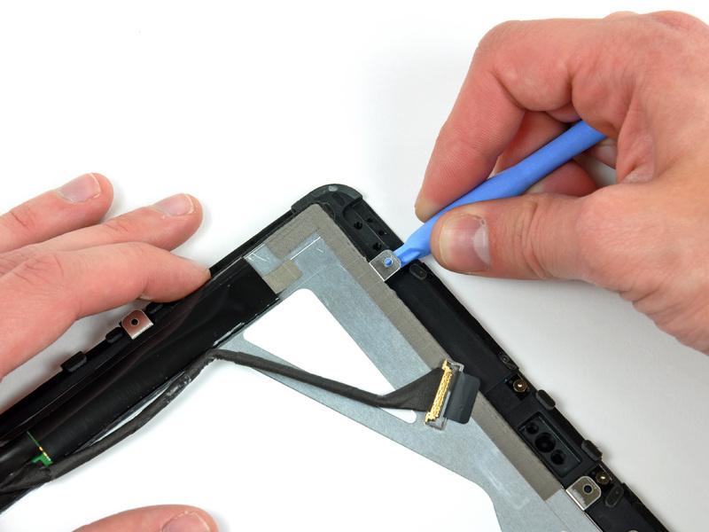 Twist the plastic opening tool to gently pry the LCD up off the