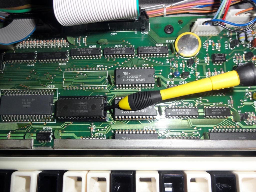 Fig. 4 - Prying up the Original ROM Step 3: Time to remove the original ROM chip IC14 from its socket.
