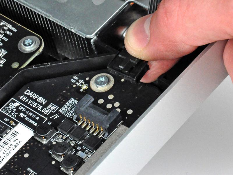 pulling the connector away from its socket (toward the bottom edge of the imac).