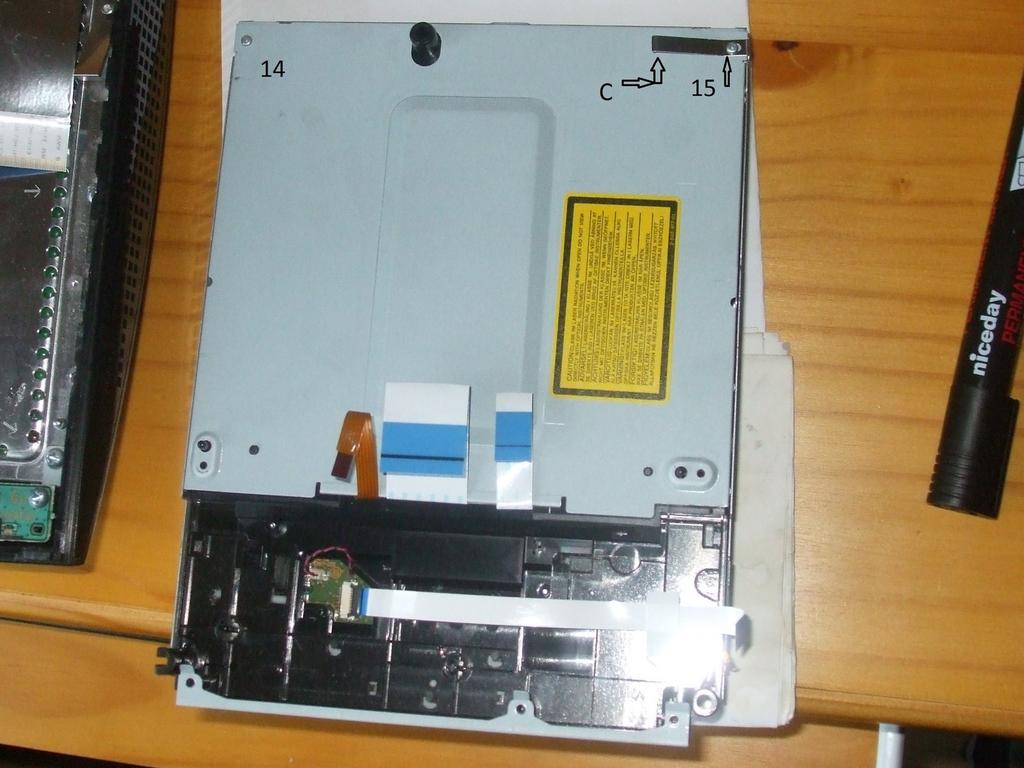 Stap 12 Remove screws 14 and 15. Part C is a stabilizer and grounding contact to help absorb movement while the Blu-ray drive is in use.