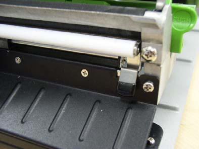 Move the label roll guard horizontally to the end of label spindle then flip down the label roll guard. 4.