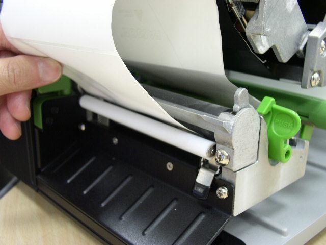 Move the label roll guard horizontally to fit the width of label roll. 5.