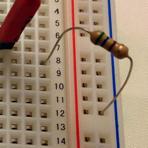 Connect the resistor from the negative (blue) column to