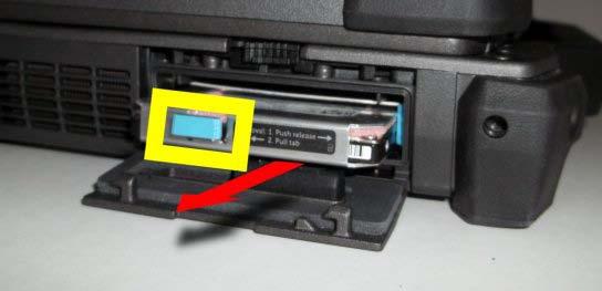 While pressing in the blue locking button, use the tab on the edge of the hard drive to pull the