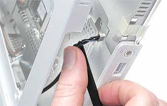 Tilt the top case so that it clears the DC connector. Tilt the top case up away from the computer latch.