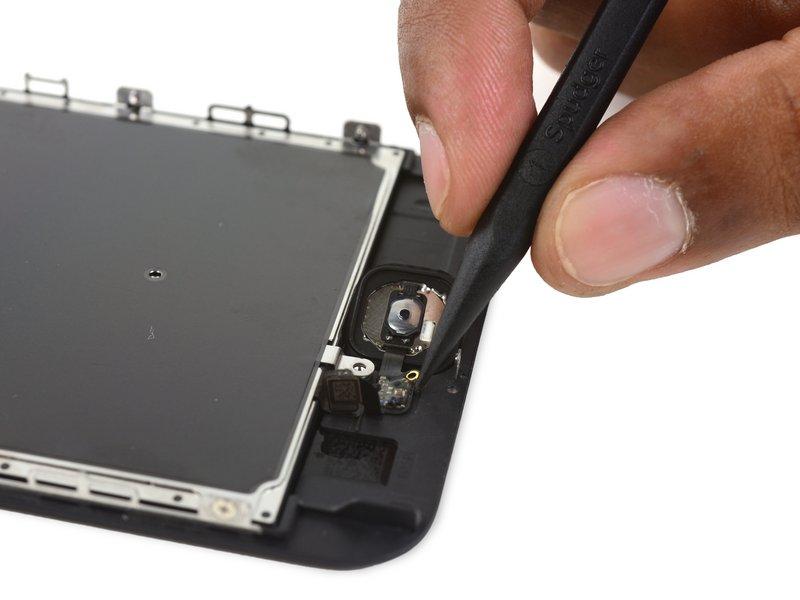 Using your fingertip, gently press up on the home button from the front side of the display assembly.