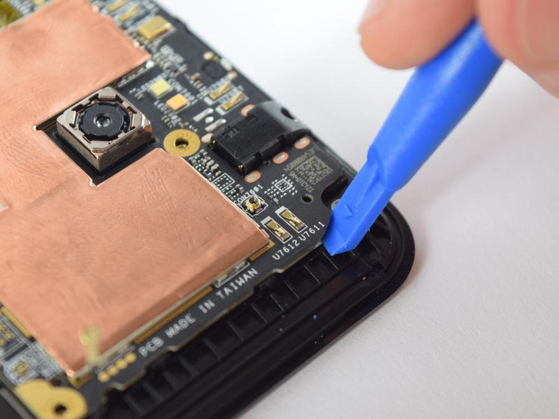 To get the motherboard out, stick a plastic opening tool under one top corner of the motherboard and carefully