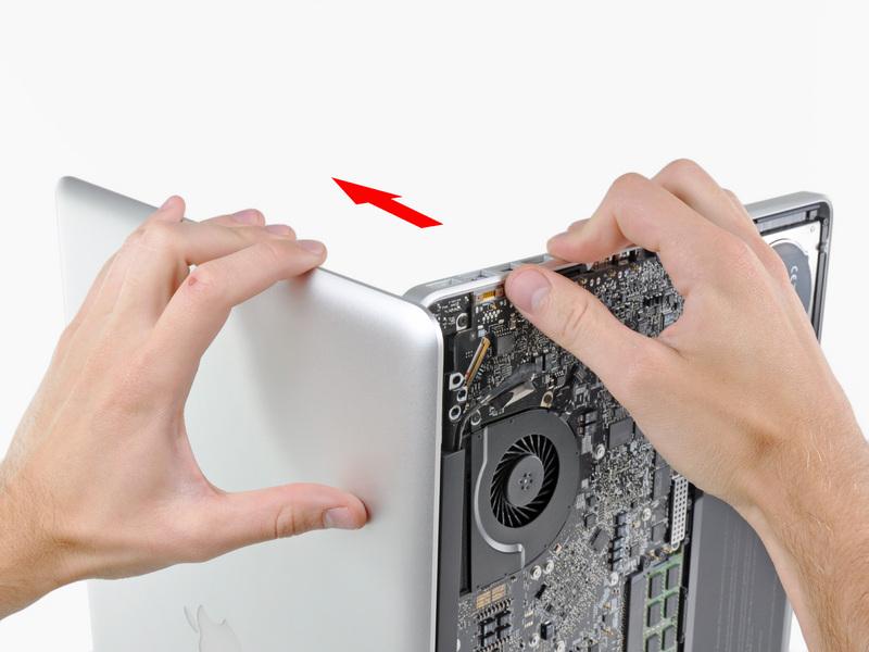 Remove the last remaining T6 Torx screw securing the display to the upper case.