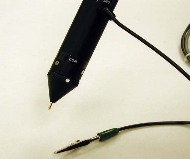 3. Use either the Black ground wire with the Green banana plug or other suitable lead to manually contact the device to initiate a discharge. Figure 3.