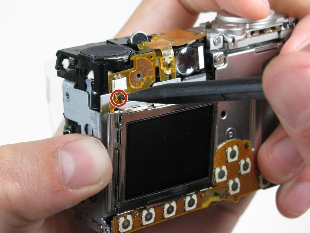 Step 7 Gently separate the top of LCD from the rest of the camera using your thumb. Be careful not pull the LCD too far because of the ribbon cable connection.