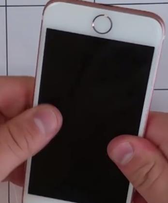 between the frame of the phone and hooks at the top