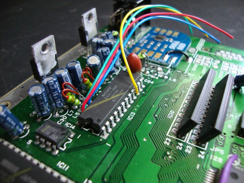 Using our four prepared coloured wires, Install them into the vacant PCB holes alongside the CXA1145 as shown.