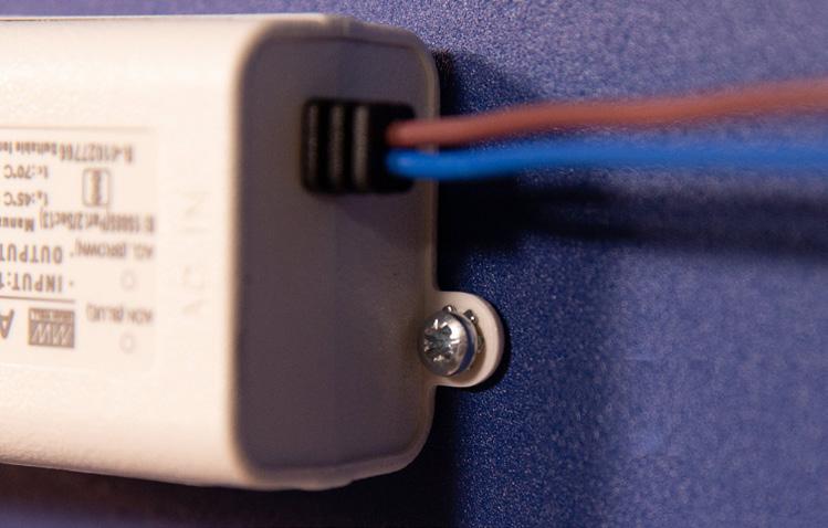 Align the bracket holes on the power supply with those matching on the back of