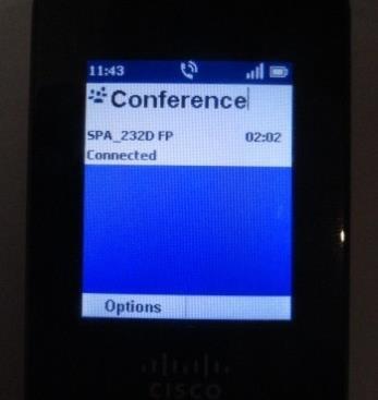 The number is automatically dialled. When the second party answers, press the Options soft key and choose Conference.