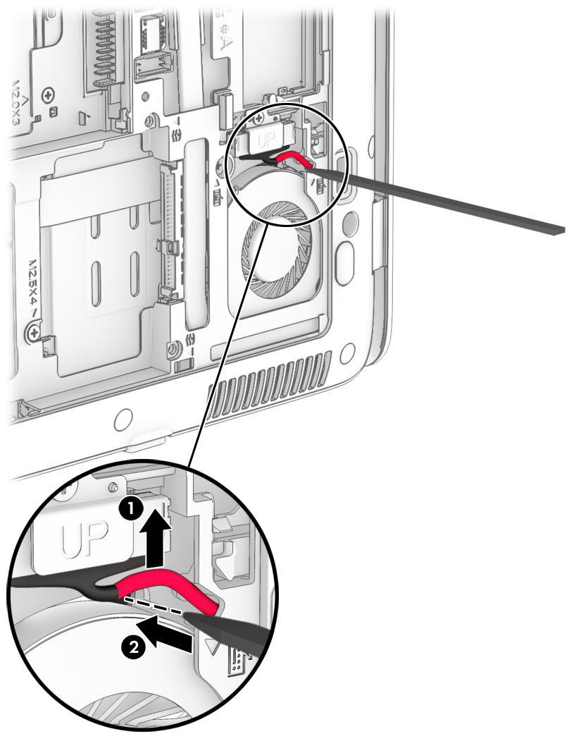 4. Insert a thin, plastic tool into the keyboard release hole next to the fan, and then press on the back of the keyboard until the keyboard disengages from the computer. 5.