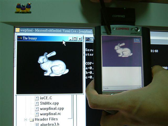 Figure 2: Our system at work. (Left) The user is changing his/her view on the Pocket PC.