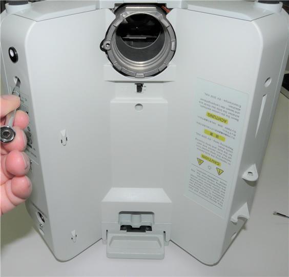 Step : Disassemble back cover. Note that after installation of the Nanodyne illuminator, there should be no power connections left in place to the DC power inlet (red circle).