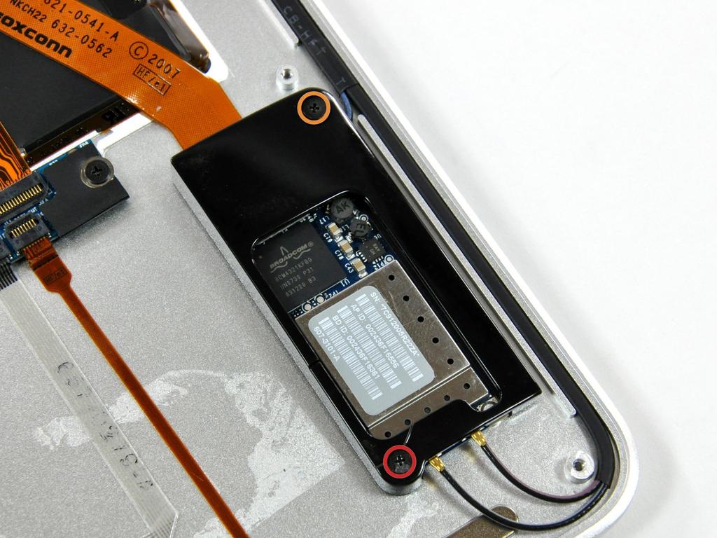 the AirPort/Bluetooth board bracket to the upper case: One 4.