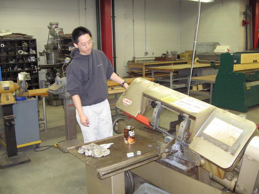 Seth using the saw at machine shop Parts Order In order to reduce the number of exposed metal ends, end caps were ordered to specifically fit the extrusions being used for the easel.