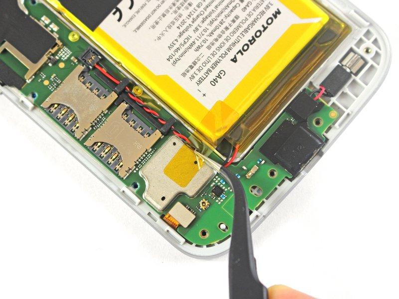 Peel up and remove the tape securing the battery wires.