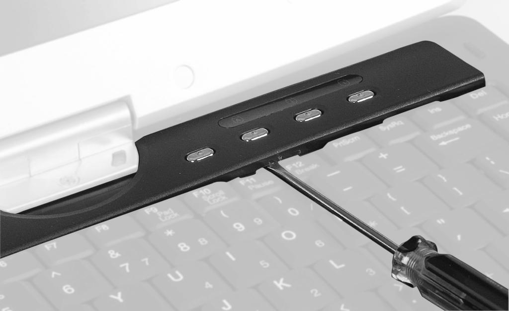10 Insert the small flat-blade screwdriver under the bottom of the keyboard bezel between the F11 and F12 keys and gently pry it up.
