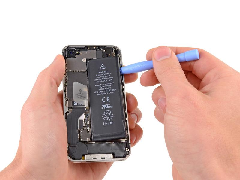 Run the plastic opening tool along the right edge of the battery and pry up
