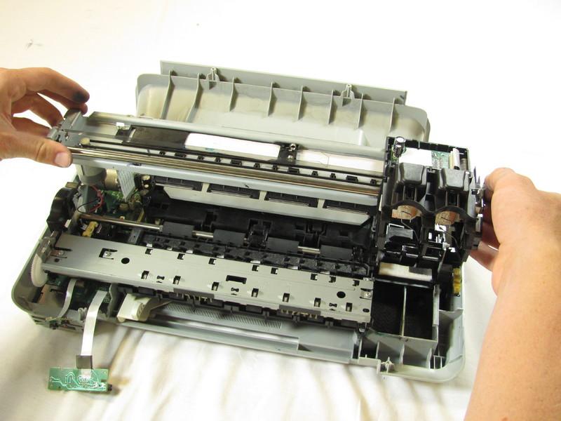 Using both hands, carefully lift the ink cartridge