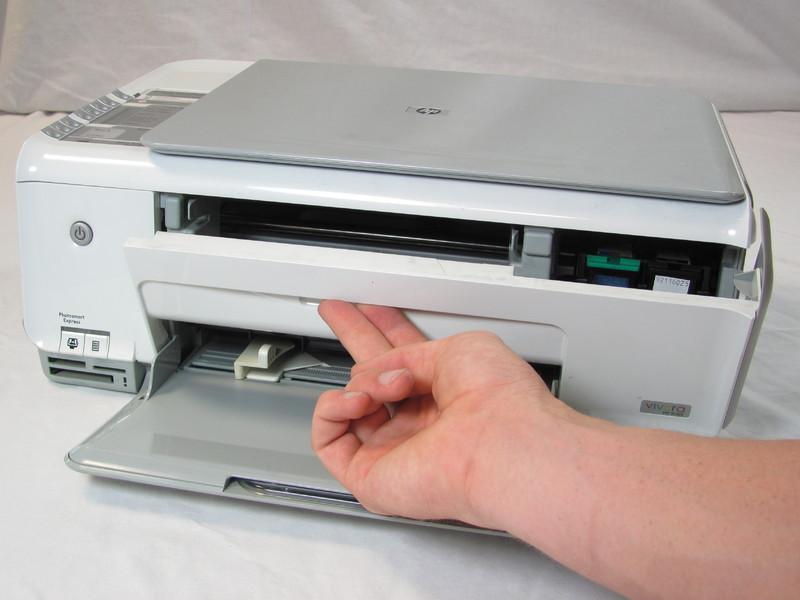 Insert your fingers into the slot in the printer door