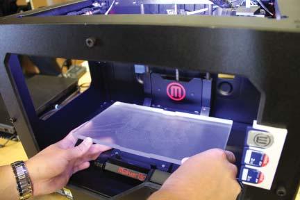 tabs.** A When placing the acrylic build plates into the 3D printers, slide the back into