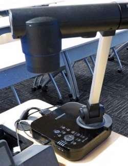 Black Samsung SDP-860 Document Camera 1. Turn the Document Camera on by pressing the Power button on the base. When turned on, a blue light will surround the Power button.